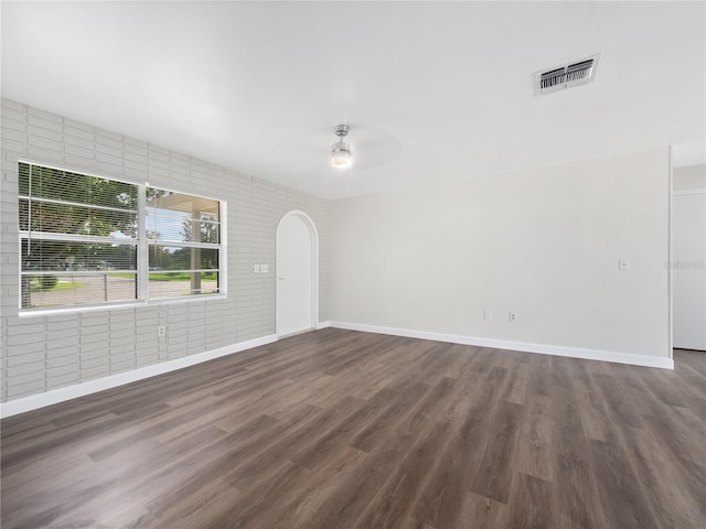 spare room with dark hardwood / wood-style floors and ceiling fan