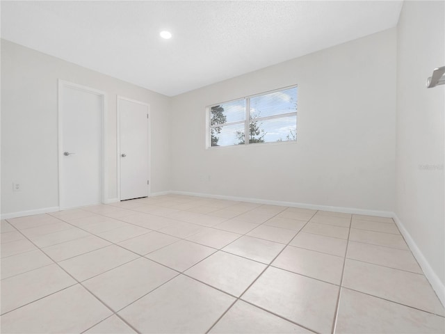 empty room with light tile patterned floors