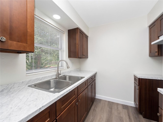 5400 Fox Briar Trl, Orlando, FL 32808 - kitchen with baseboards, light countertops, a sink, and dark wood finished floors