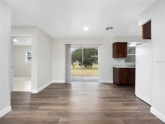 unfurnished living room featuring dark wood-type flooring