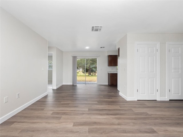 5400 Fox Briar Trl, Orlando, FL 32808 - unfurnished living room with visible vents, baseboards, and wood finished floors