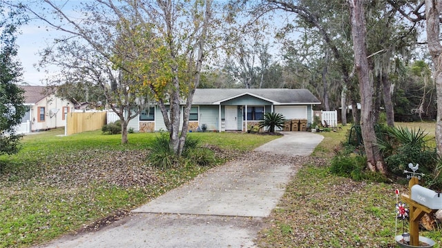 single story home with a front lawn and covered porch