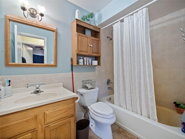 full bathroom featuring vanity, toilet, shower / bathtub combination with curtain, tile walls, and tile patterned flooring