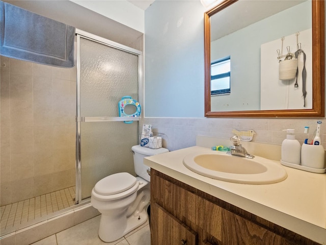 bathroom featuring vanity, an enclosed shower, tile patterned floors, tile walls, and toilet