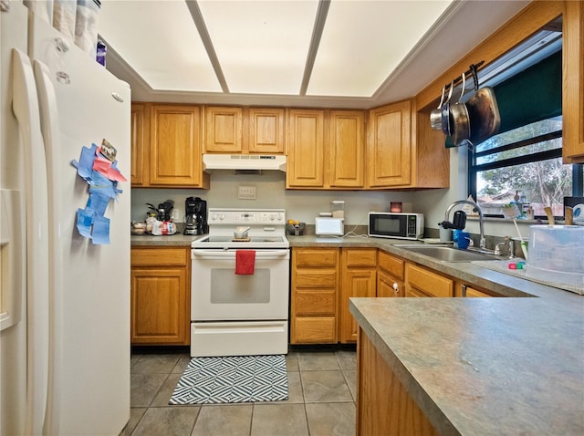 kitchen featuring white appliances, light tile patterned flooring, and sink