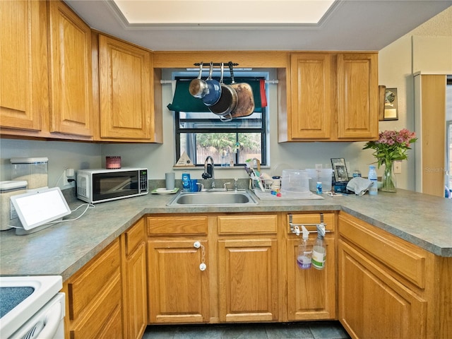 kitchen featuring white range oven and sink