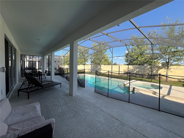 view of swimming pool with a lanai, a patio, and an in ground hot tub