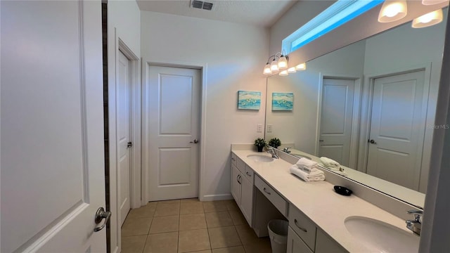 bathroom with vanity, tile patterned floors, and a textured ceiling