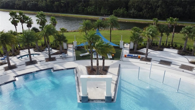 view of pool featuring a patio area and a yard