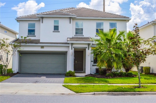 view of front facade featuring a front yard and a garage