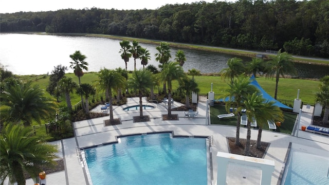 view of pool featuring a patio area and a water view