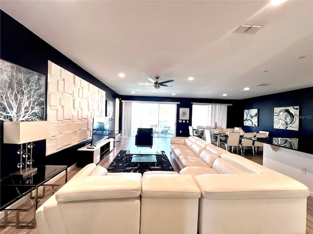 living room featuring ceiling fan and wood-type flooring