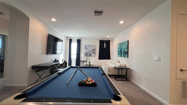 game room featuring a textured ceiling, carpet flooring, and billiards