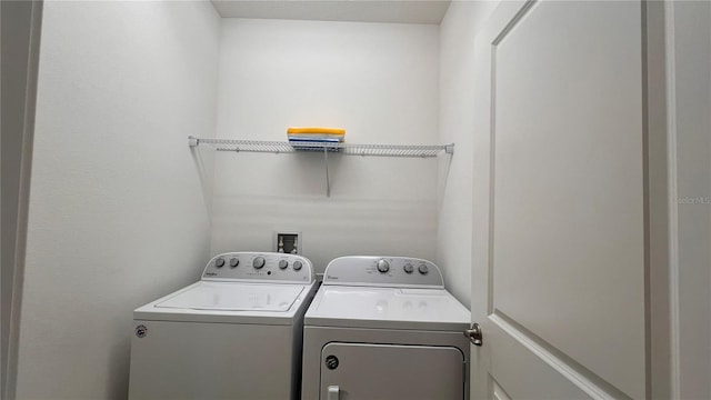 laundry room featuring separate washer and dryer