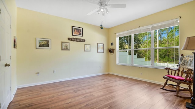 sitting room featuring ceiling fan and light wood-type flooring