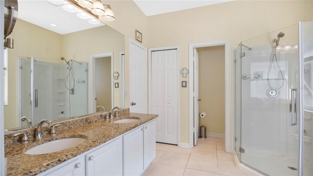 bathroom with walk in shower, tile patterned floors, and vanity