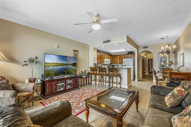 tiled living room featuring ceiling fan with notable chandelier and crown molding