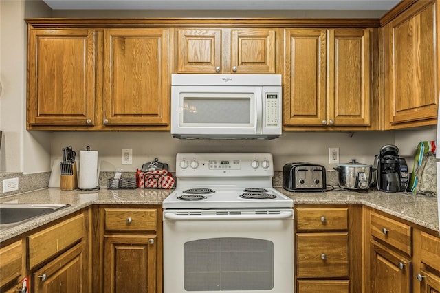 kitchen with white appliances and light stone counters