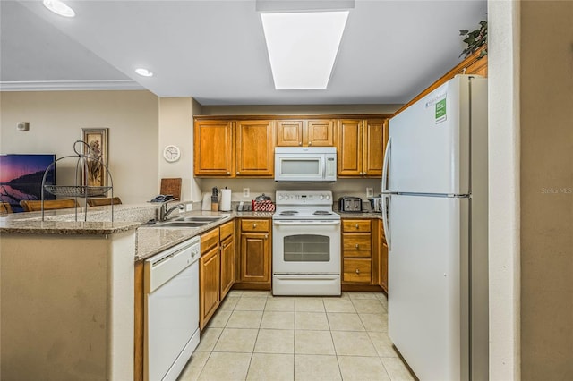 kitchen featuring white appliances, stone counters, crown molding, sink, and kitchen peninsula