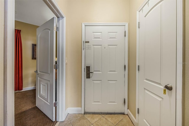 corridor featuring light tile patterned floors