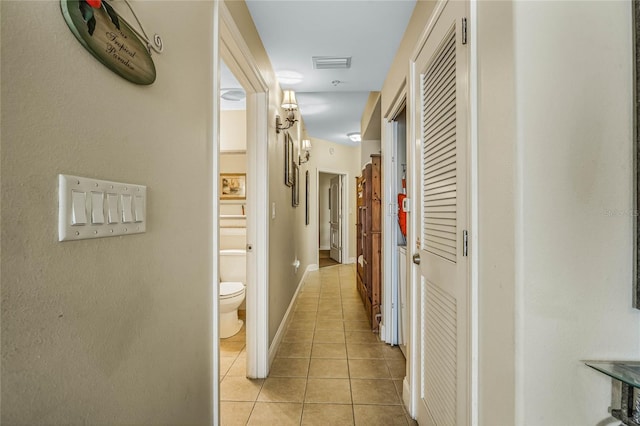 hallway featuring light tile patterned floors