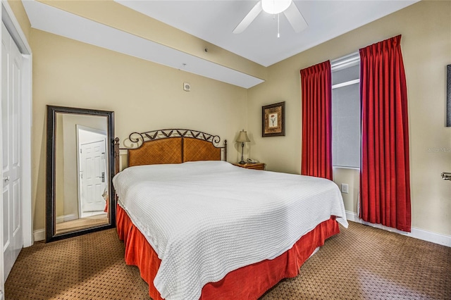 carpeted bedroom featuring ceiling fan and a closet