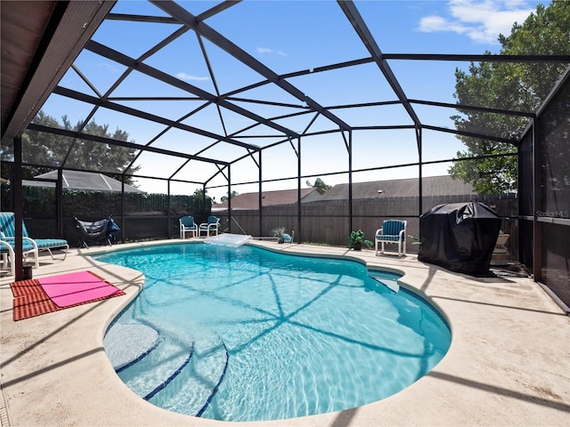 view of swimming pool with area for grilling, a lanai, and a patio area