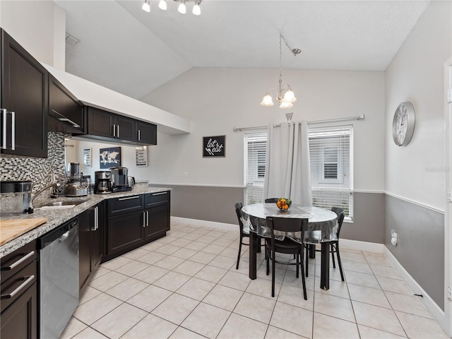 kitchen featuring hanging light fixtures, tasteful backsplash, stainless steel dishwasher, sink, and a notable chandelier