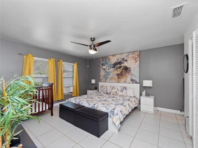 tiled bedroom featuring ceiling fan