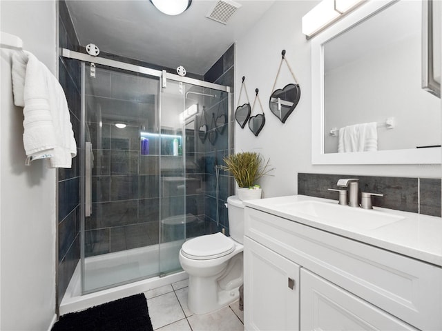 bathroom featuring vanity, toilet, an enclosed shower, and tile patterned floors