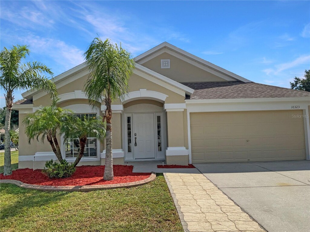10323 Soaring Eagle Dr, Riverview, FL 33578 - view of front of home featuring driveway, stucco siding, and a garage