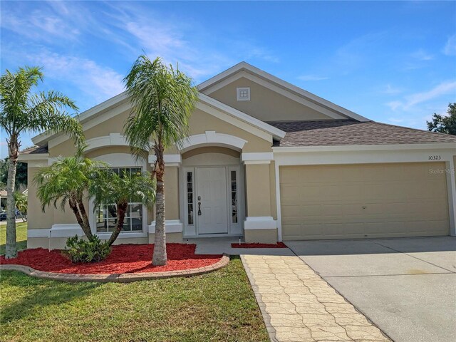 10323 Soaring Eagle Dr, Riverview, FL 33578 - view of front of home featuring driveway, stucco siding, and a garage
