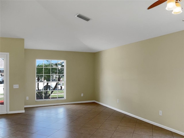 tiled empty room featuring ceiling fan