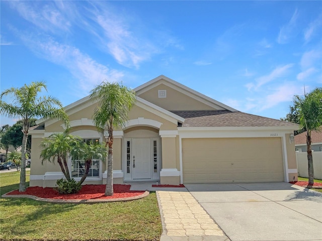 view of front of home featuring a front yard and a garage