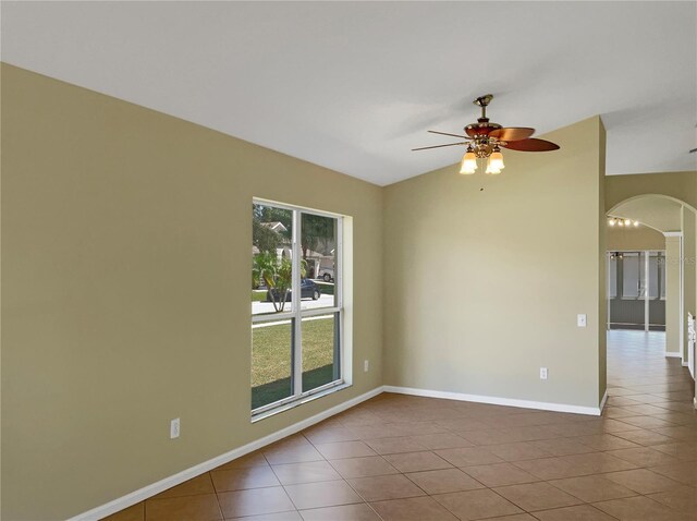 unfurnished room featuring vaulted ceiling, ceiling fan, and tile patterned floors