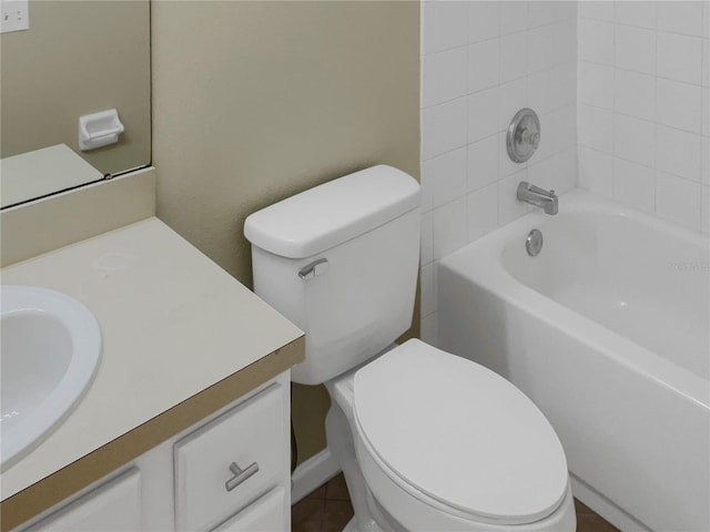 full bathroom featuring tiled shower / bath combo, vanity, toilet, and tile patterned floors