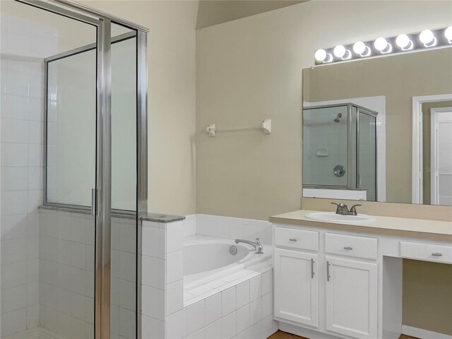 bathroom with vanity and plus walk in shower