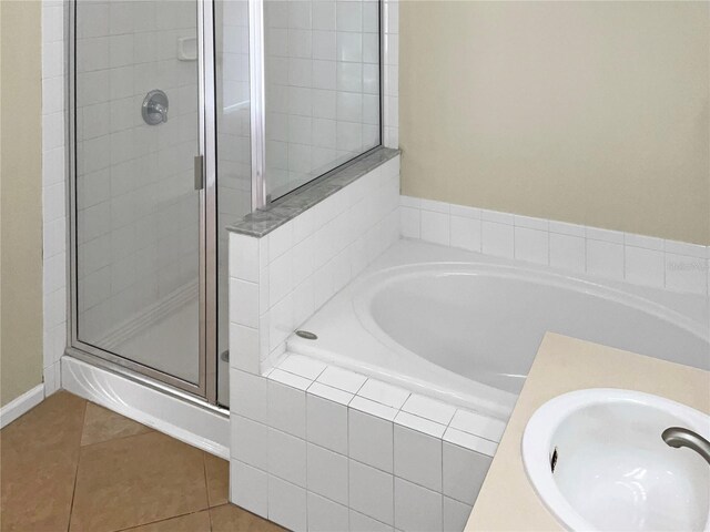 bathroom featuring tile patterned flooring, vanity, and separate shower and tub