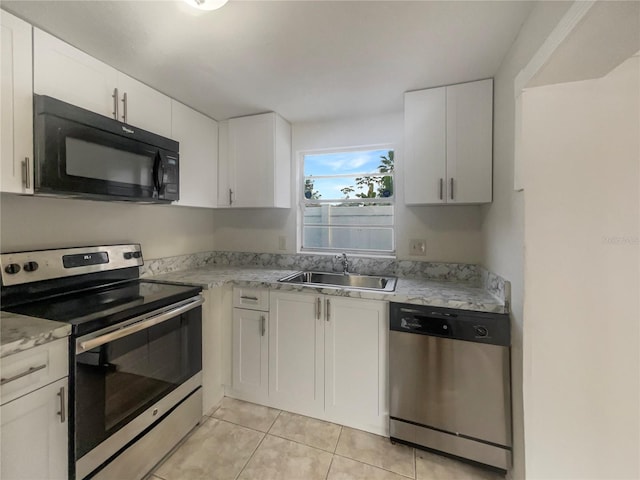 kitchen featuring light tile patterned flooring, white cabinetry, sink, and stainless steel appliances