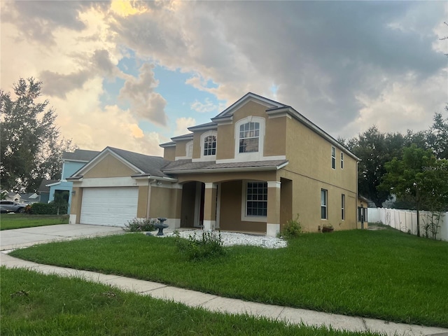 view of front of house with a garage, a porch, and a lawn