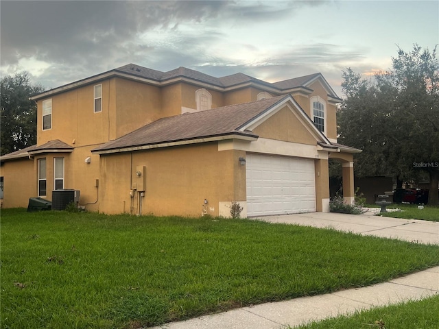 view of side of property featuring central AC and a yard