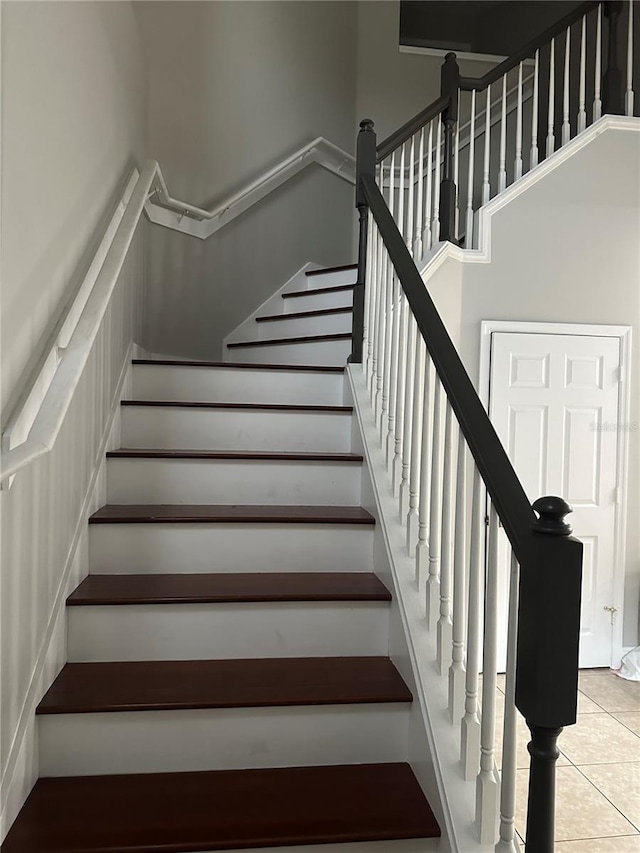 stairway featuring tile patterned floors