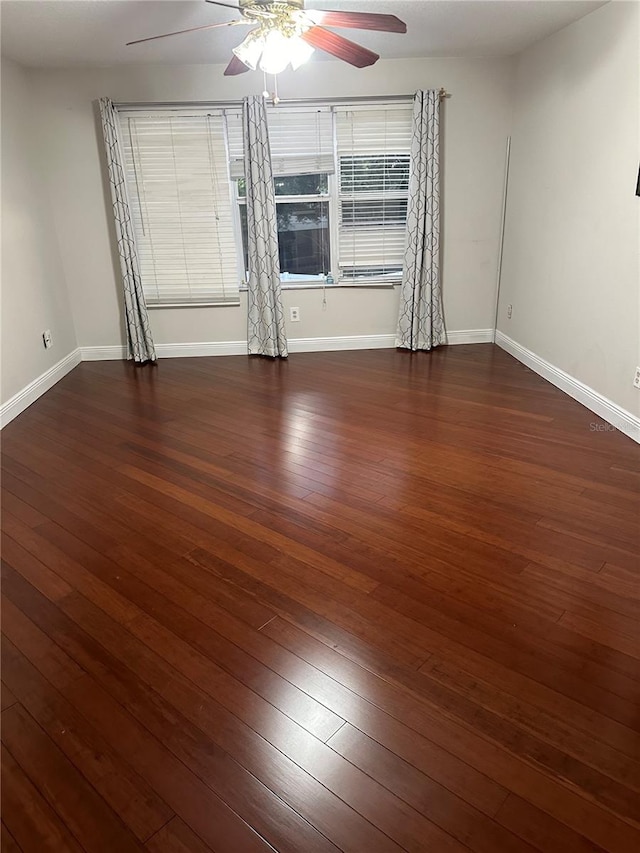 empty room featuring ceiling fan and dark hardwood / wood-style flooring