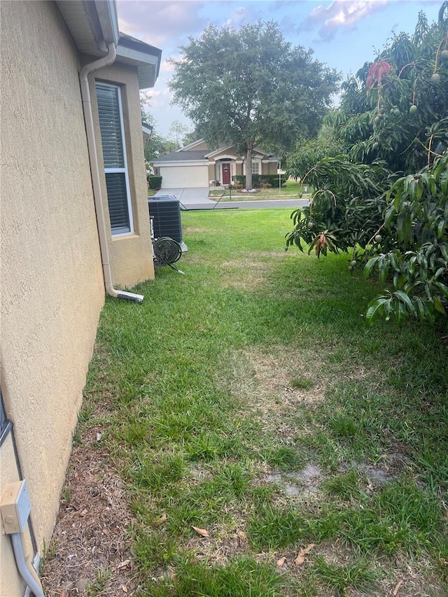 view of yard with central AC unit