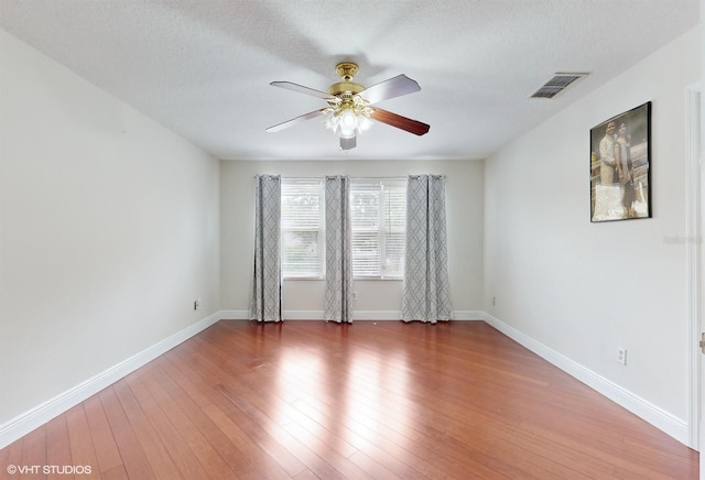 1278 Snug Harbor Dr, Casselberry, FL 32707 - spare room with baseboards, a textured ceiling, visible vents, hardwood / wood-style floors, and ceiling fan