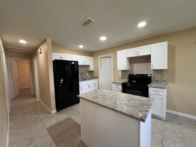 kitchen featuring white cabinets, sink, tasteful backsplash, and black appliances