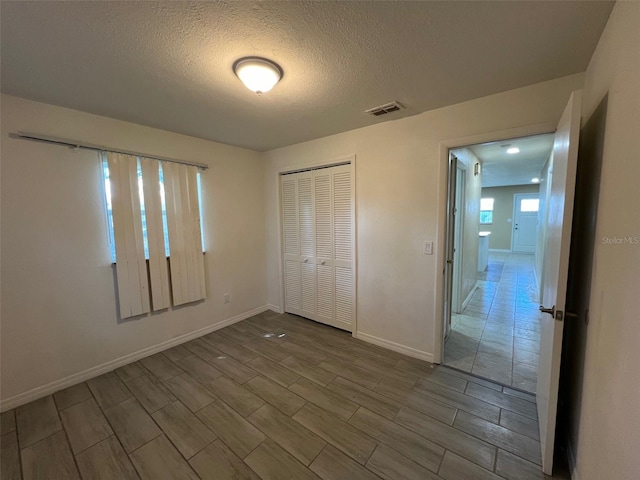 interior space with a textured ceiling and a closet