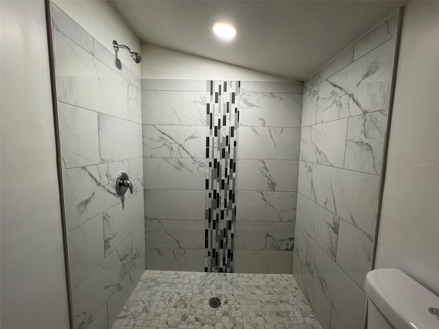 bathroom featuring toilet and tiled shower