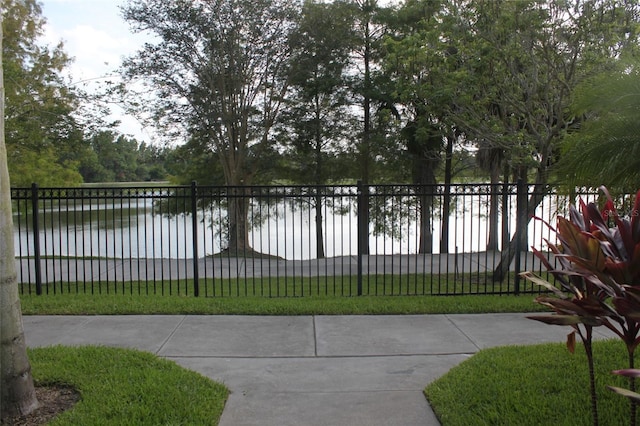 exterior space with a water view and a yard