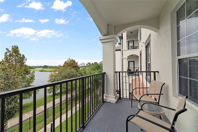 balcony featuring a water view